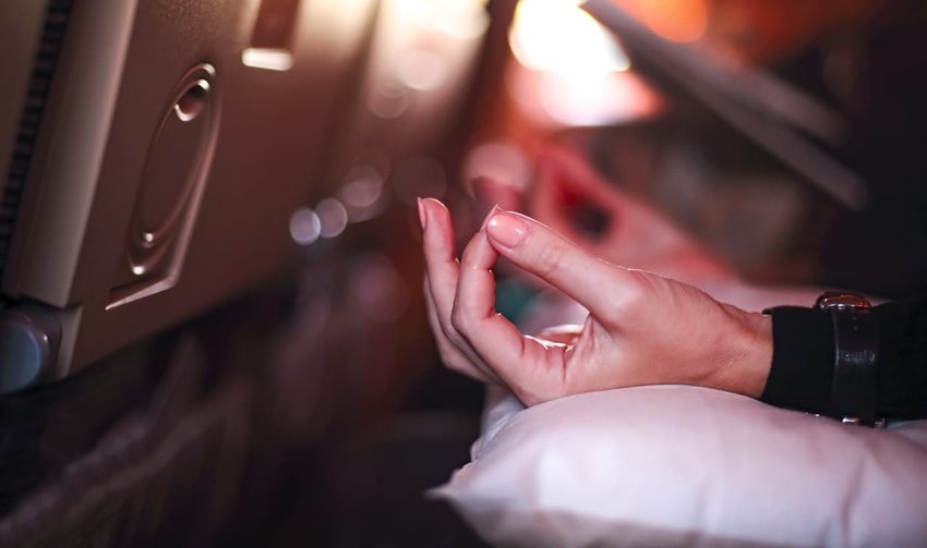 woman on plane meditating