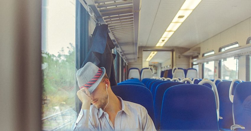 man sleeping on train during commute