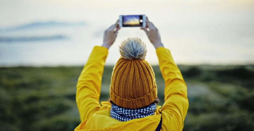 tourist taking photo of ocean