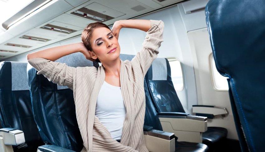 Woman stretching on an airplane