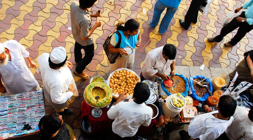 People in Mumbai buying snacks on street market