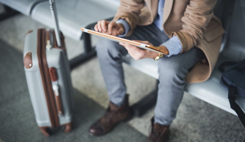 Man uses digital tablet in lounge airport