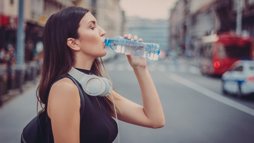 woman drinking water from water bottle