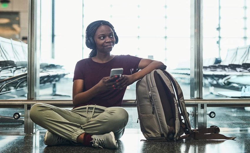 woman Listening to some music while waiting on departure