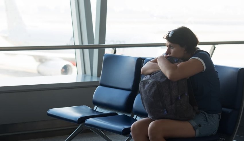 tired woman sitting in airport terminal