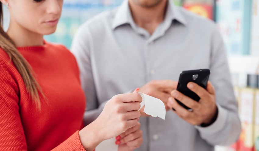 young couple reviewing shopping receipt