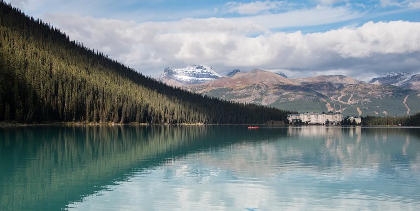 Mountain peaks and Fairmont Chateau reflected in Lake Louise, Banff National Park, Canadian Rockies