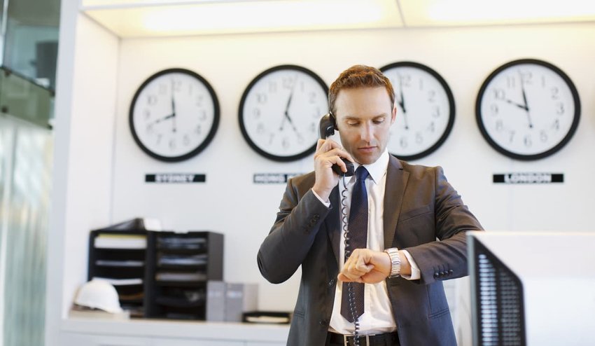 Businessman checking his watch in office