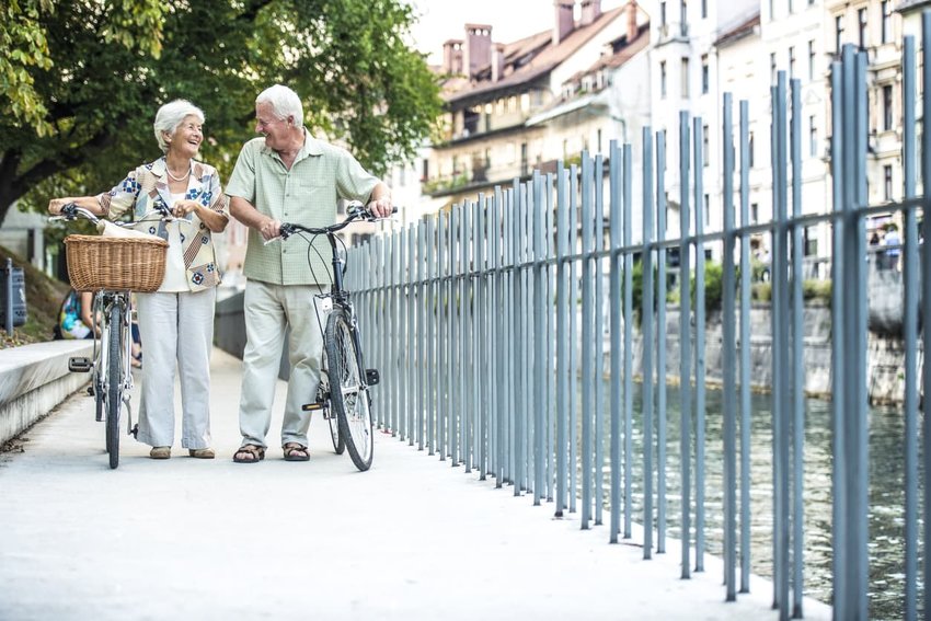 Senior couple with their bikes on city street