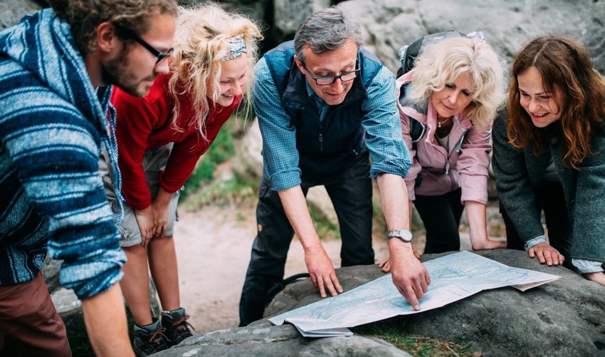 Group of Hikers checking route on map