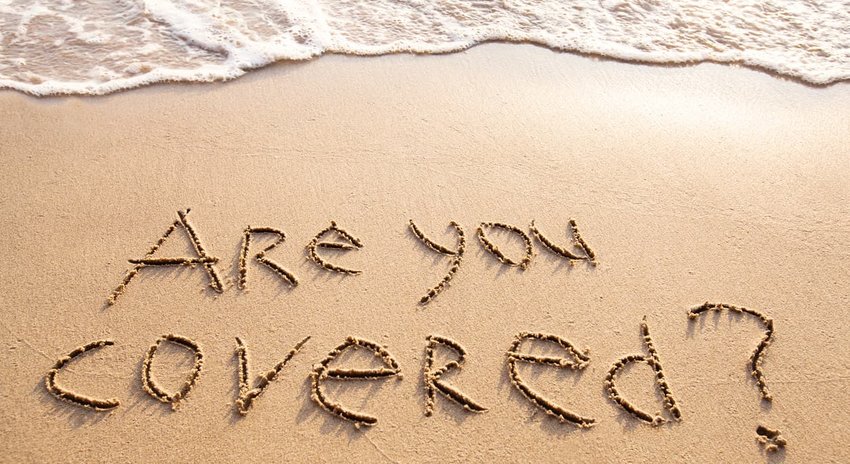 Are you covered travel insurance concept written in sand