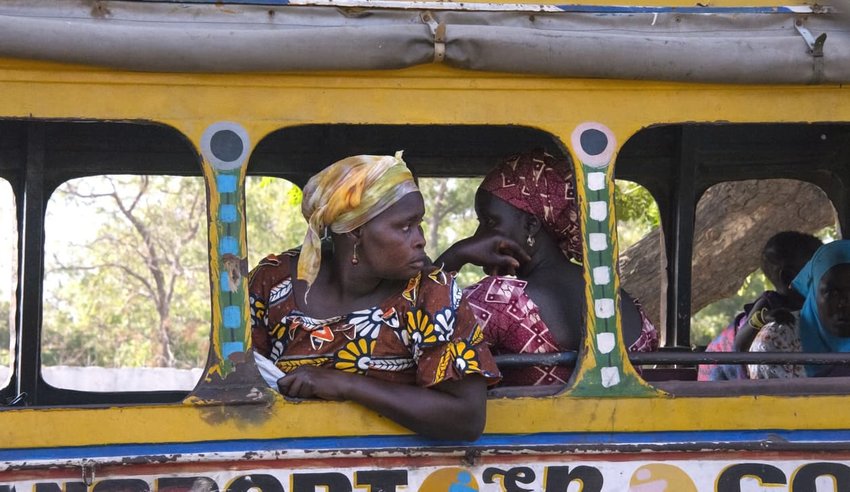 Woman leaning on a Dakar bus