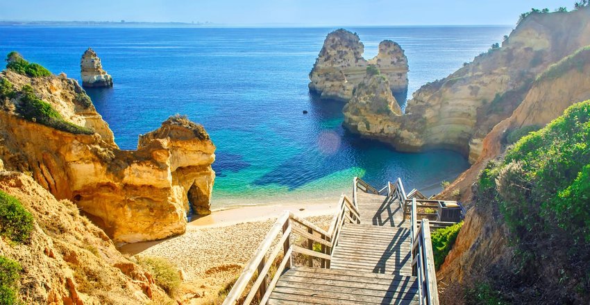 Wooden footbridge to beautiful beach Praia do Camilo near Lagos