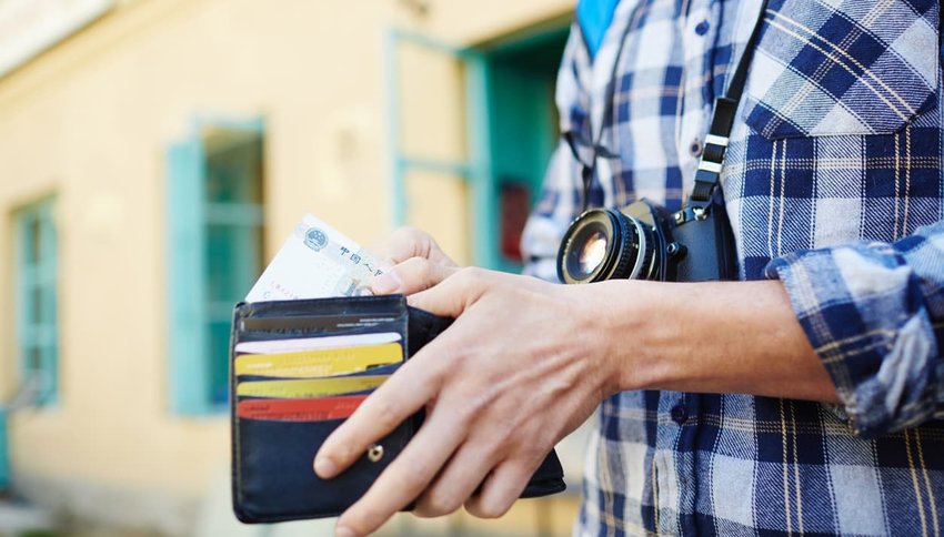 Young man saving money for travelling