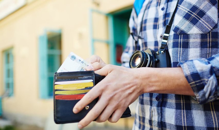 Young Man Saving Money for Traveling