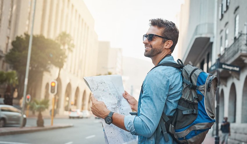 tourist wearing backpack holding map