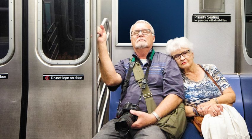 senior tourist couple asleep on the train after a long day