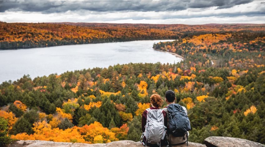 Young couple hiking in mountain and relaxing looking at view