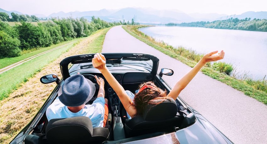 Couple in love ride in cabriolet car 