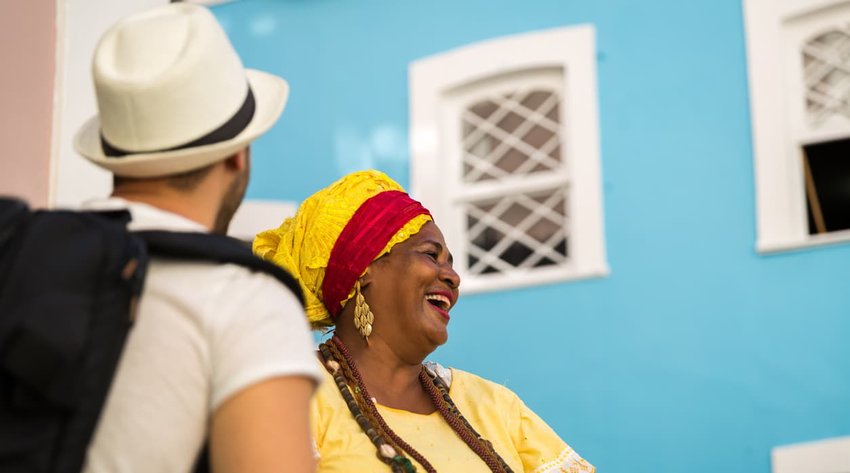 Tourist dancing with local Brazilian woman 'Baiana' in Pelourinho, Salvador, Bahia, Brazil