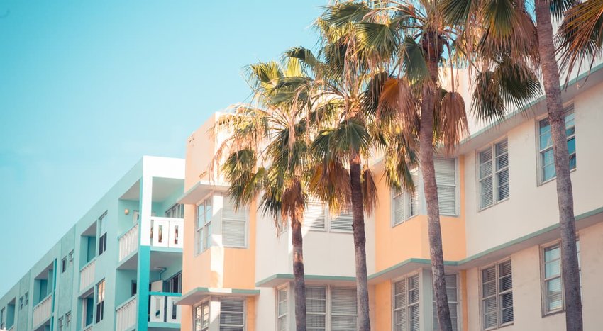 Typical pastel-colored 1930s Art Deco architecture with palm trees in Miami, Florida