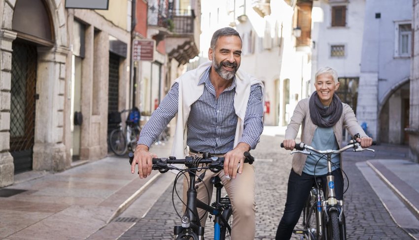 older couple exploring a european city by bike