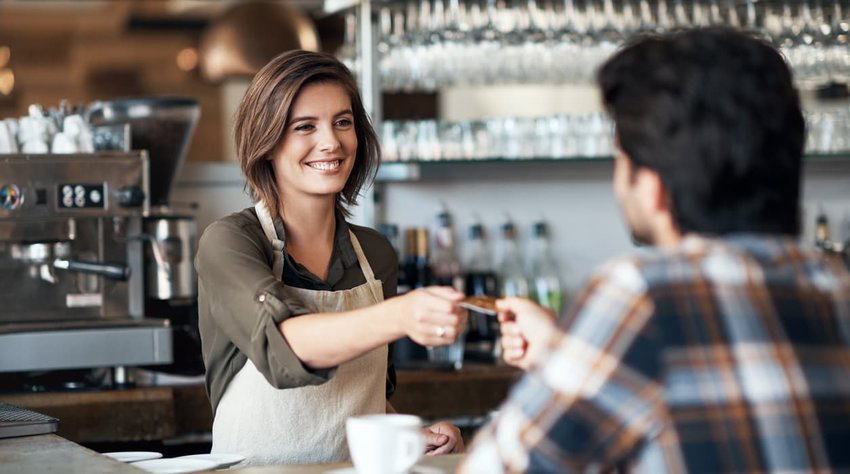 barista helping customer at counter