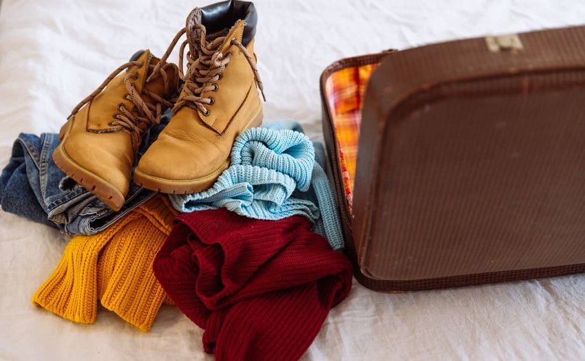 Woman clothes near old vintage suitcase