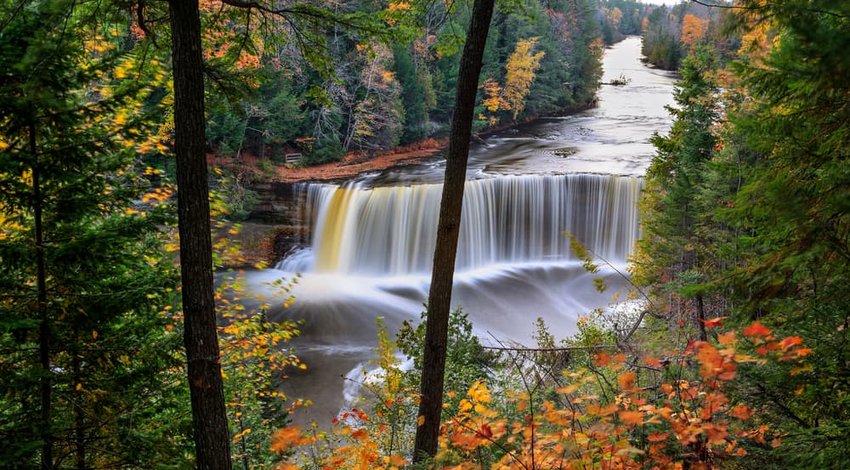 Picturesque waterfall in motion blur, Tahquamenon Falls in autumn, Michigan's Upper Peninsula