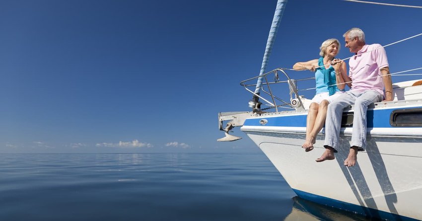 Happy Senior Couple on the Bow of a Sail Boat