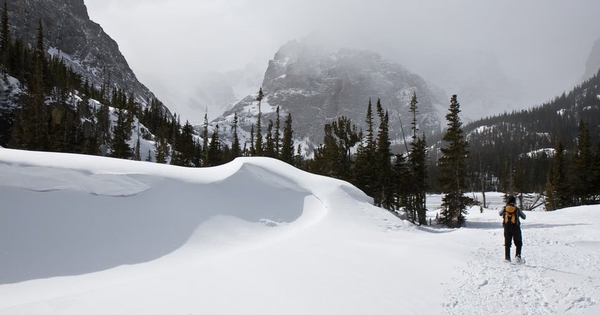 Person Snowshoeing Past Snow Drift in Rocky Mountain National Park