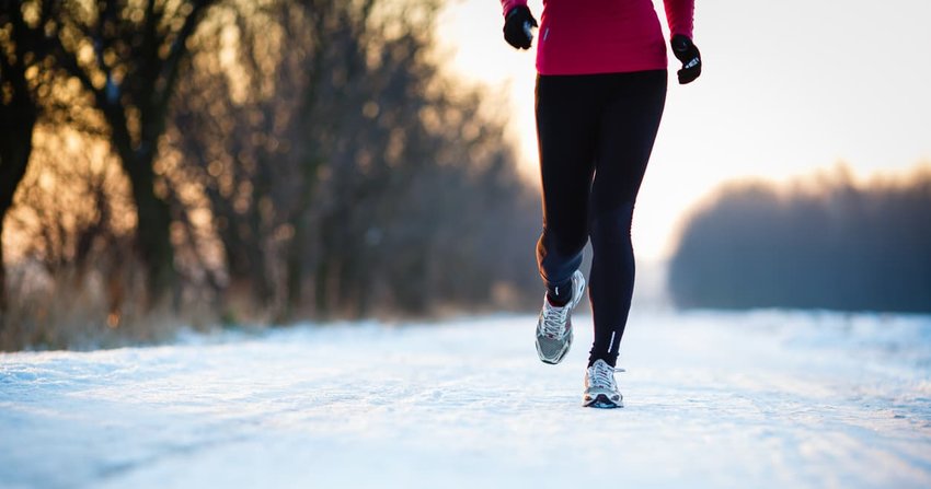 Young woman running outdoors on a cold winter day