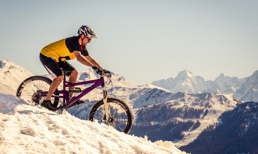 Mountain biker riding on the snow