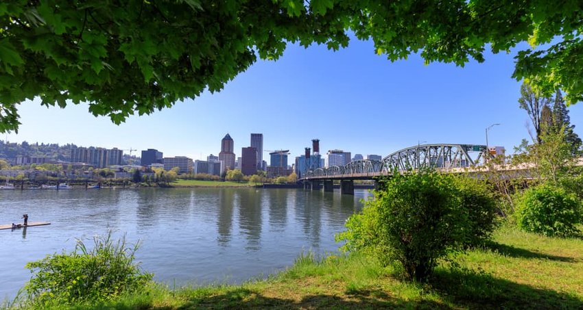 Hawthorne bridge on Willamette river with cityscape and skyline in portland