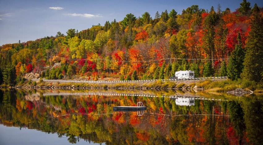 Fall forest with colorful autumn leaves reflecting in Lake of Two Rivers. Algonquin Park, Ontario, Canada.