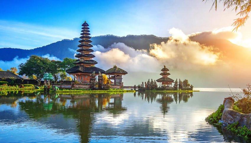 Photo of Bali temples on a lake, with mountains in the distance