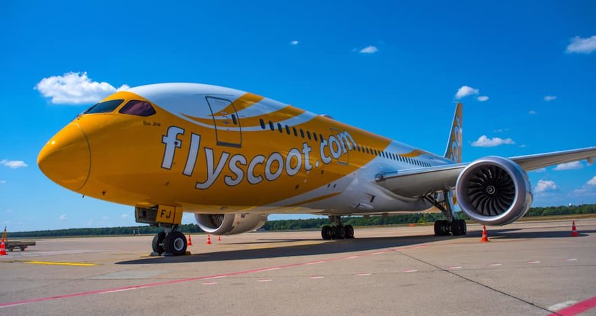 Photo of a plane that says flyscoot.com on the side