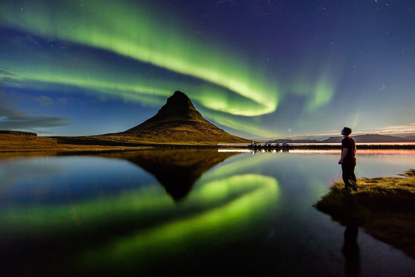 Person observing the Northern Lights in Kirkjufell, Iceland