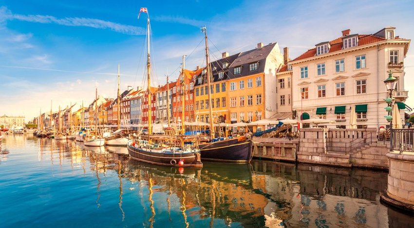 Colorful buildings and boats set by a river