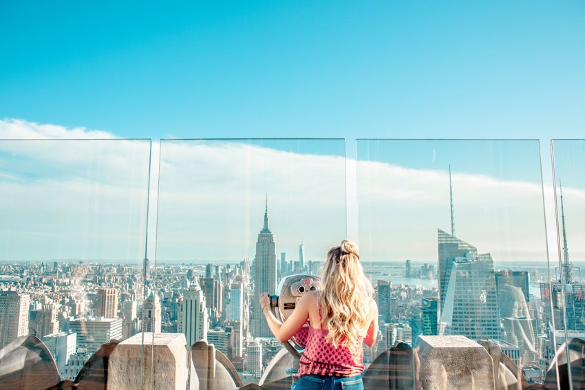 Photo of woman looking out over Manhattan, NY