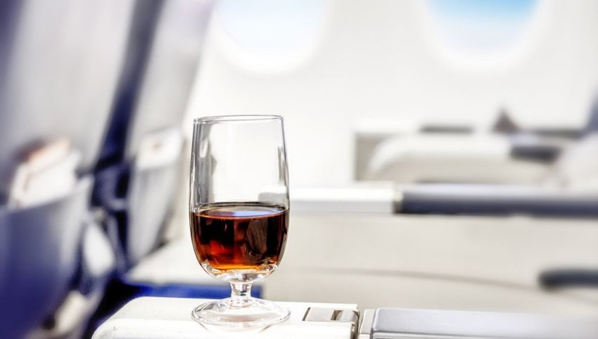 Cocktail glass on a plane tray table