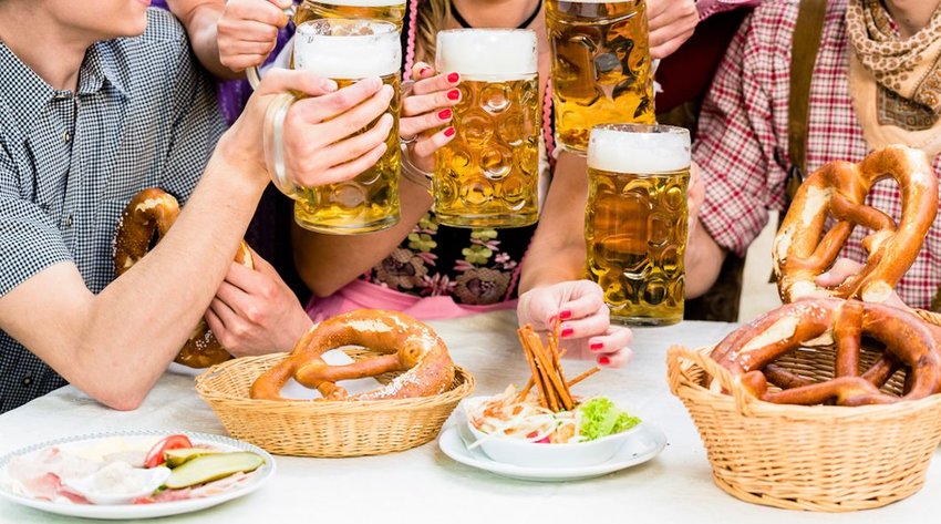 People enjoying beer and hot pretzels