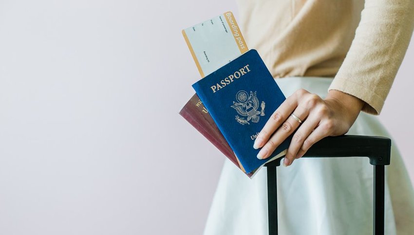 Woman holding passports and boarding pass