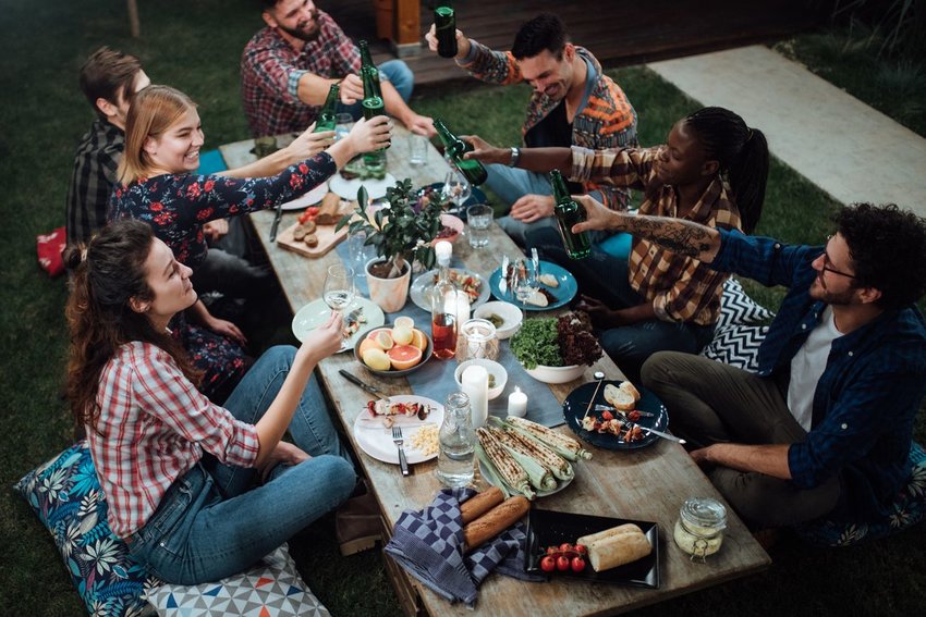 Photo of friends around an outdoor dinner table