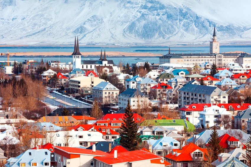 Aerial photo of the city of Reykjavik with a mountain in the background