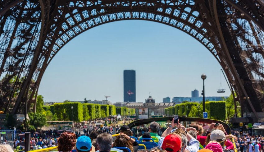 Crowds of tourists under the Eiffel Tower