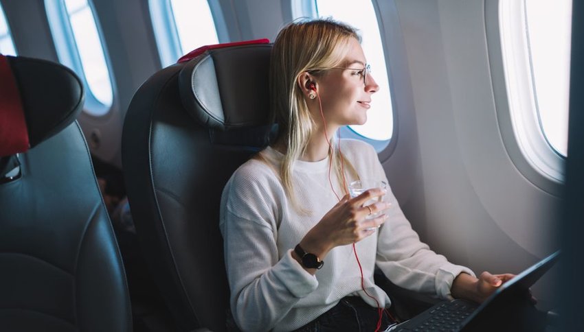 smiling woman enjoying her comfortable flight