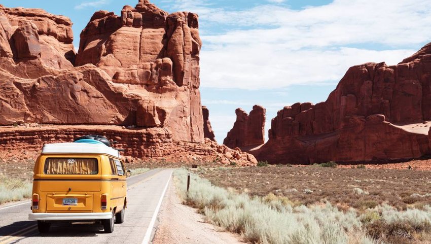 Car driving at Arches National Park Entrance Station, Moab, US.