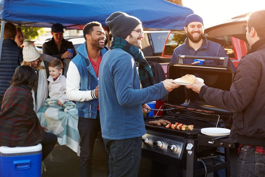 Friends gathered around a grill