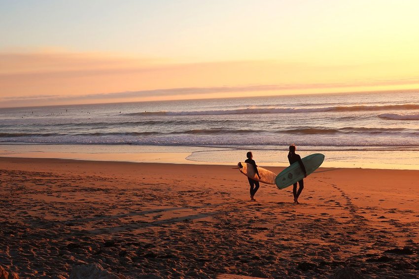 Two surfers at the shore